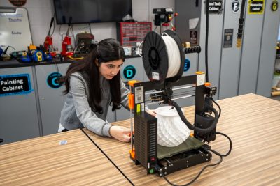 Ayda Haydarpour works on a 3D printer in the Prototyping studio in Newman Library. Haydarpour is a computer science student in the College of Engineering and was part of the Afghan Girls Robotics Team, which is the focus of a recent movie, "Rule Breakers."
