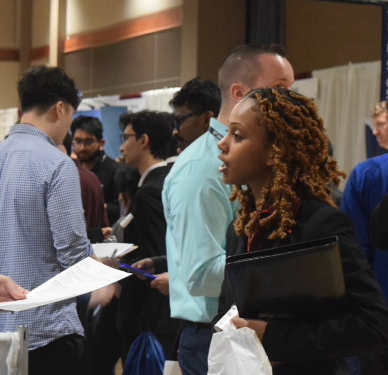 Image of student speaking to company rep at career fair