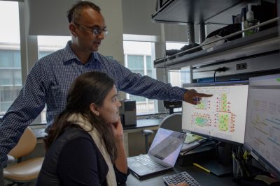 bioinformatics researchers at work around a desktop