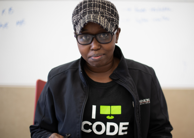 Female computer science student wearing a shirt that says 'I Code.'