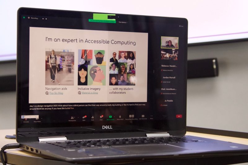 Student facing a computer screen showing a hybrid webinar forum.